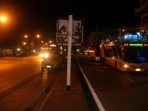 A long distance bus takes a break during a journey through the night in Thailand