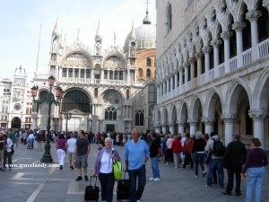 Tourists queue up to get into the bell tower (out of frame in the left) at St Mark's Square in Venice