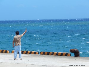 An official checks the wind speed at the Yoron pier