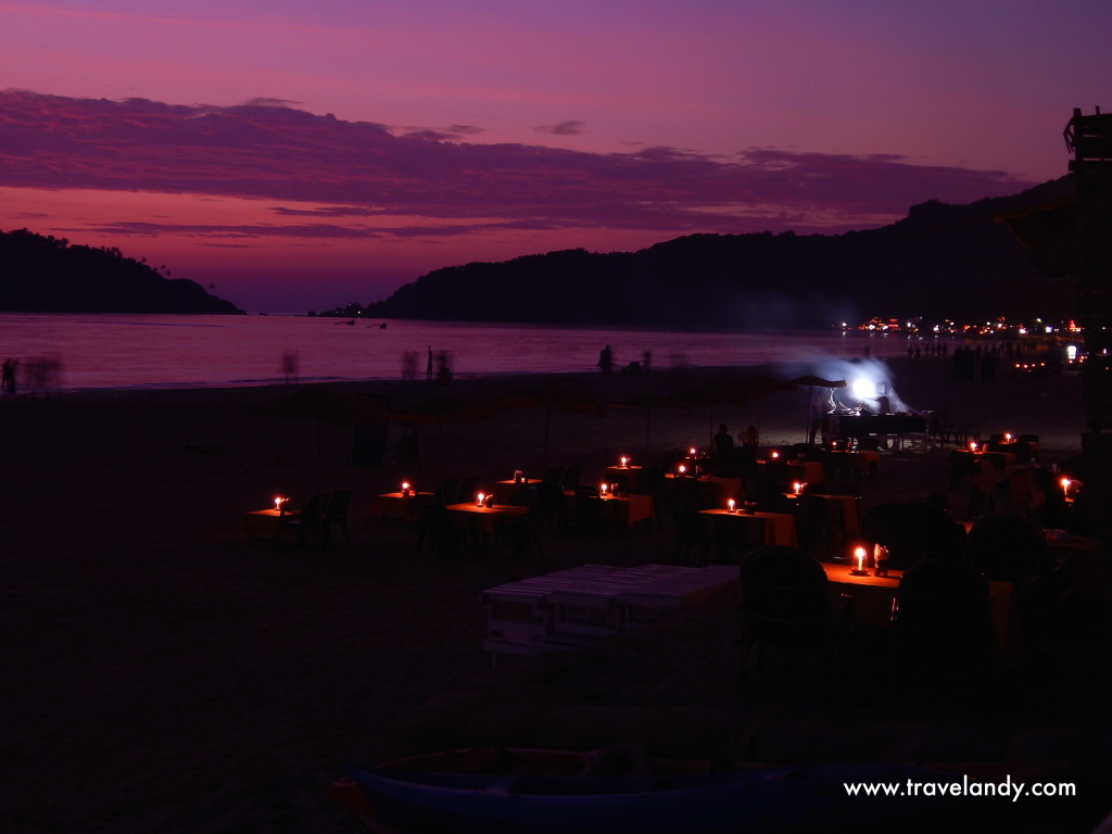 Palolem beach at dusk. The cafes set up these tables so that you can sit right on the beach and have dinner 