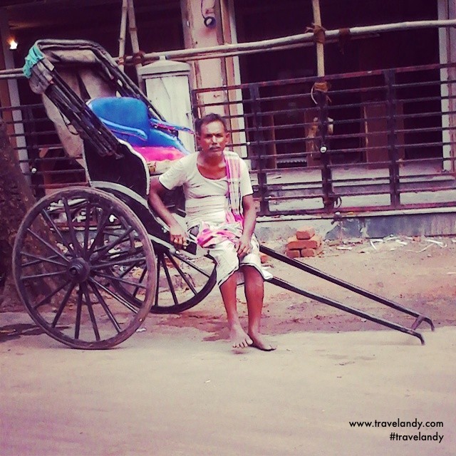 A hand-rickshaw puller waits for passengers at Sudder Street in Kolkata